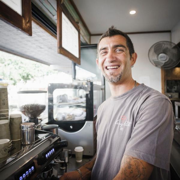 Male barista preparing coffee at cafe