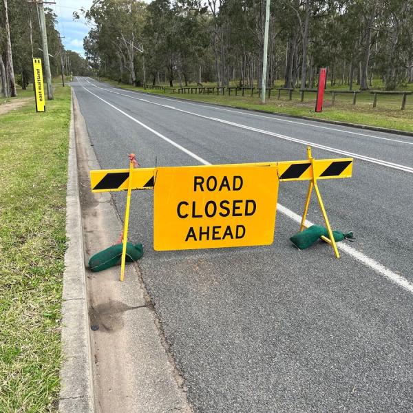 Road closed ahead sign on side of road