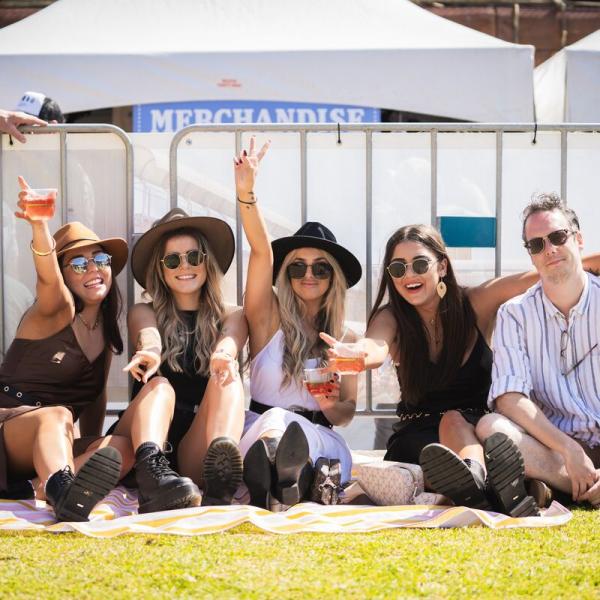 Group of people sitting on grass at Bitter & Twisted Festival