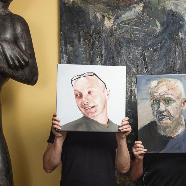 Image caption: Benefactors Gordon Elliott and Michael Eyes, holding works artists Euan Macleod (Gordon) and Juan Ford (Michael), both oils on board. Photographer Christoper Pearce