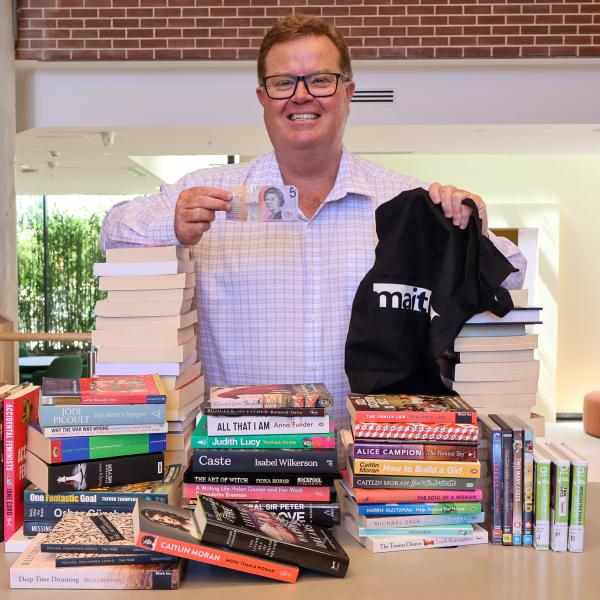 Maitland Mayor Philip Penfold with stacks of second-hand books at Maitland Town Hall