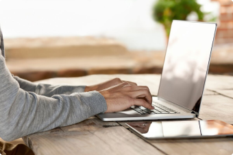 person typing on a laptop computer