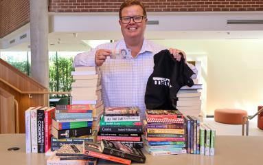 Maitland Mayor Philip Penfold with stacks of second-hand books at Maitland Town Hall