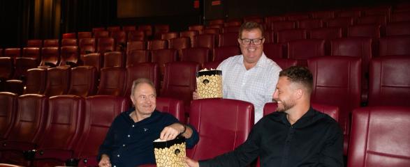 Craig Hamilton sitting with Mayor Philip Penfold and Jye Currie in the movie cinema