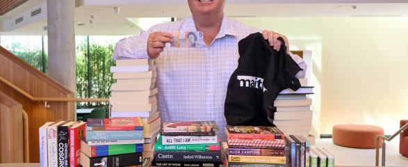 Maitland Mayor Philip Penfold with stacks of second-hand books at Maitland Town Hall